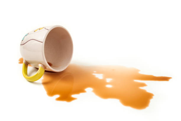 istock Coffee spill from a blue cup on white background, soft focus close up 2163162131