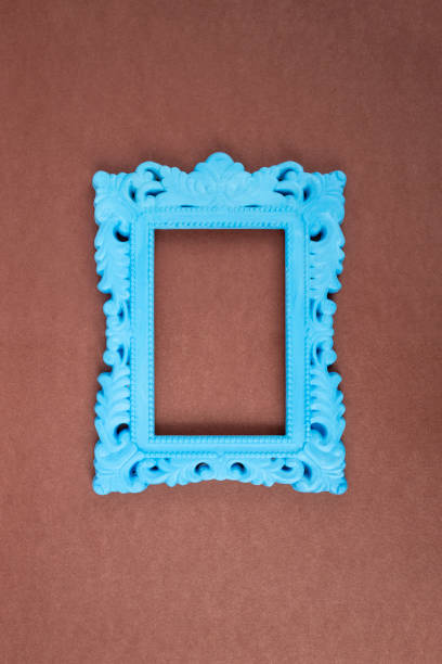 Blue painted baroque frame on brown paper background,