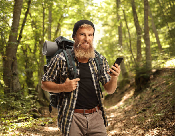 istock Bearded man hiker holding a mobile phone 2163163191