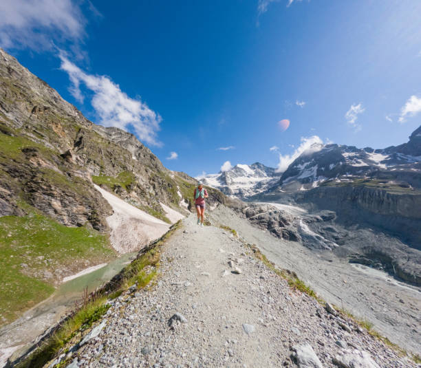 istock Female Trail Runner on Rocky Mountain Path with Glacier View 2163163280