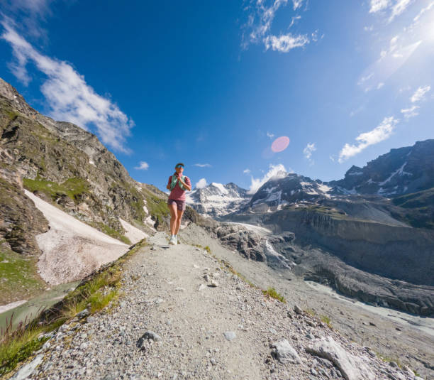 istock Female Trail Runner on Rocky Mountain Path with Glacier View 2163163306