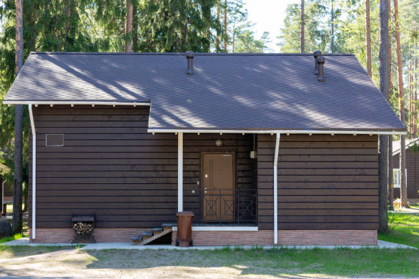A house made of brown timber, showcasing a rustic charm with its wooden exterior and natural grain patterns