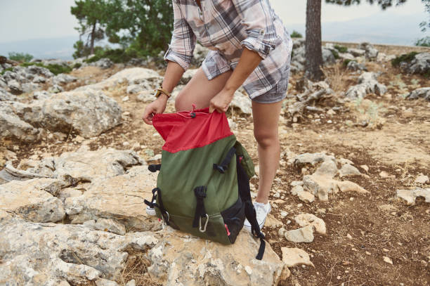 istock Hiker adjusting backpack in rocky terrain during outdoor adventure 2163166819
