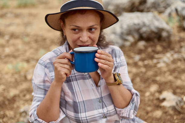istock Woman enjoying a hot beverage outdoors while relaxing during a hike 2163166895