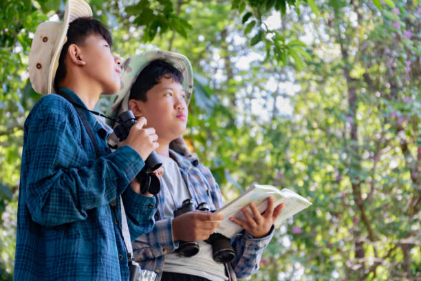 istock Asian boys with birdwatching activity 2163168624