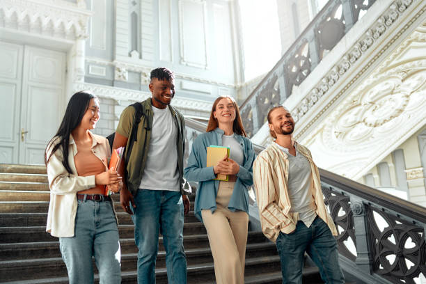 College students bonding in a historic building stairwell on campus, creating a lively atmosphere