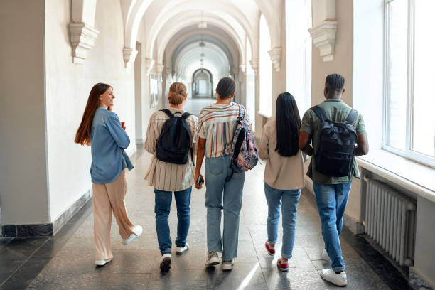 istock Students walking in university hallway, showing friendship, collaboration, academic pursuit 2163169943