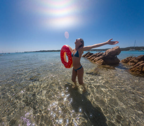 istock Woman Enjoying the Beach with Inflatable Ring 2163175025