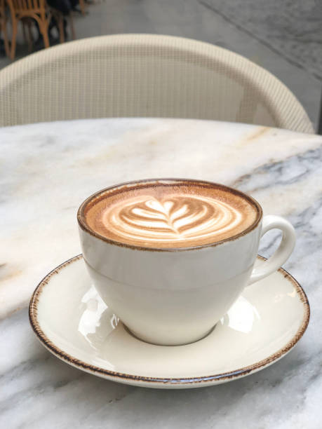 istock cappuccino coffee with latte art on marble table at cafe 2163175350