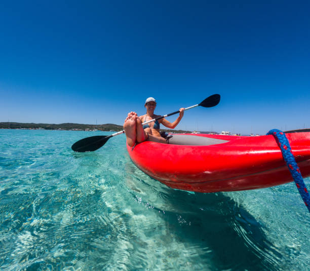 istock Woman Kayaking in Crystal Clear Waters 2163175865