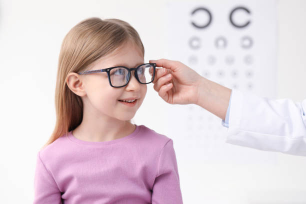 istock Vision testing. Little girl trying glasses at ophthalmologist office 2163176376