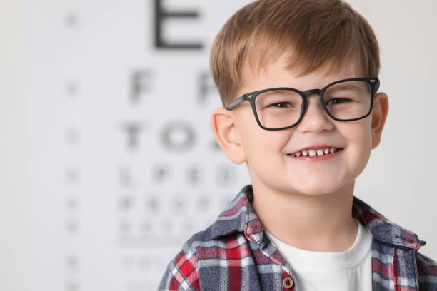 istock Little boy with glasses against vision test chart 2163176614