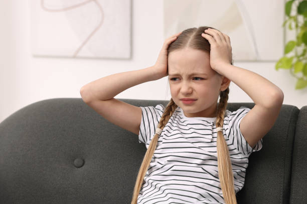 istock Little girl suffering from headache on sofa indoors 2163176662