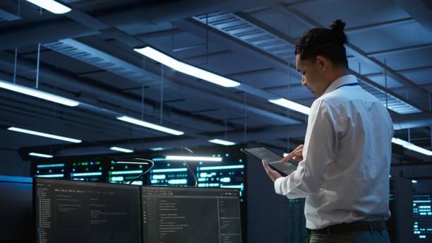 istock IT expert in server room tracking network traffic with tablet 2163177043