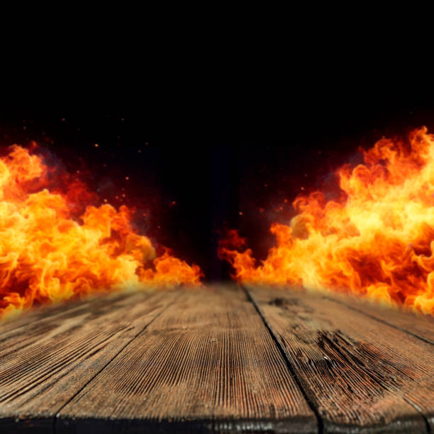 istock Fire flames isolated on wooden table and black wall background, copy space for products. 2163177512