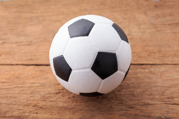 istock soccer ball on wooden floor 2163179295
