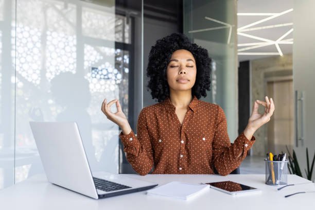 istock Businesswoman practicing mindfulness at her office desk 2163180122