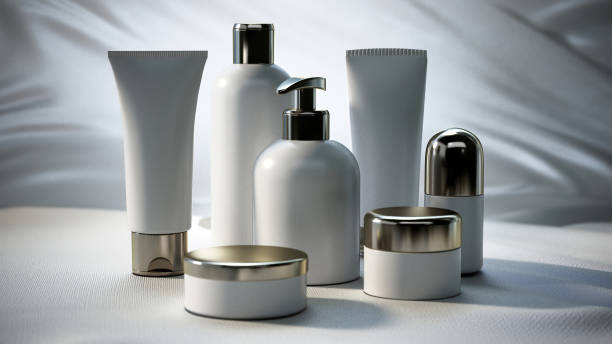 Seven bottles of various sizes, shapes, and materials, each with a silver cap, standing on a white surface.