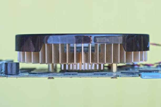 one brown fan on an electronic video card on a yellow background