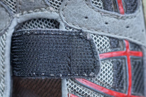 one black velcro fastener on a gray sneaker