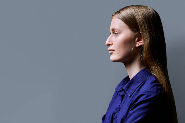 istock Profile view, confident young woman, copy space gray studio background 2163183011
