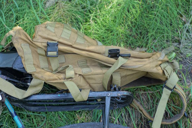 istock one brown army backpack lies on a black bicycle rack 2163183440