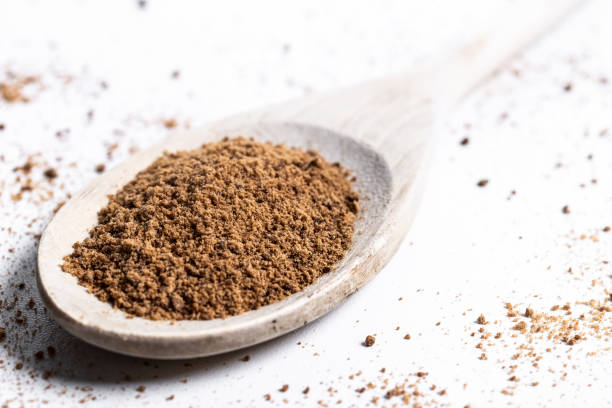 istock Coconut palm sugar on a wooden spoon isolated on white background 2163184277