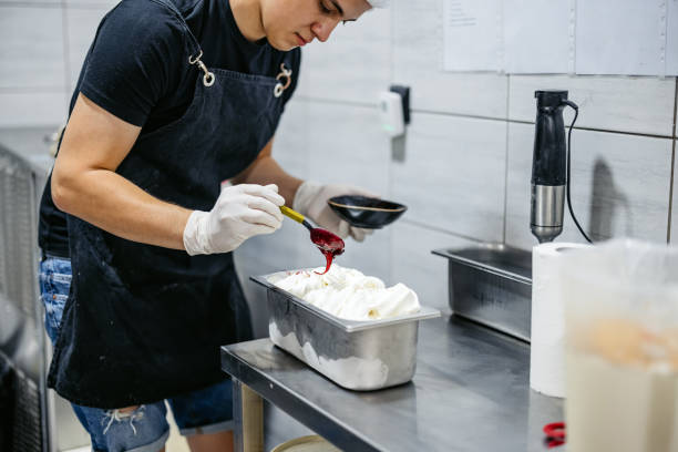 istock Young Man Decorating Ice Cream In An Ice Cream Shop 2163185199