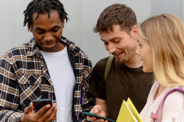 istock group of friends using a smartphone 2163188423