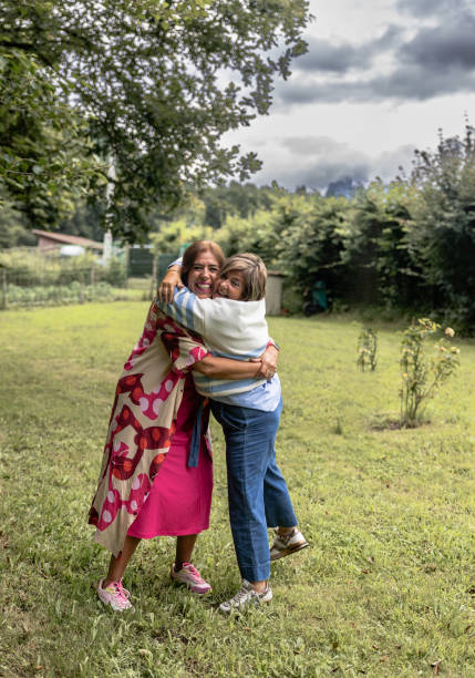 istock Two friends hugging at countryside gathering, copy space. 2163188887