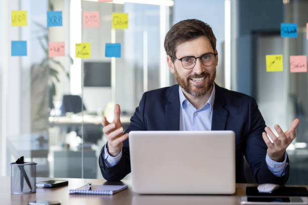 istock Confident businessman in office discussing project ideas with a smile 2163190620
