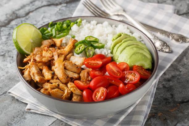 istock Rice bowl with pulled chicken carnitas, cherry tomatoes, avocado, peppers close-up. Horizontal 2163190827