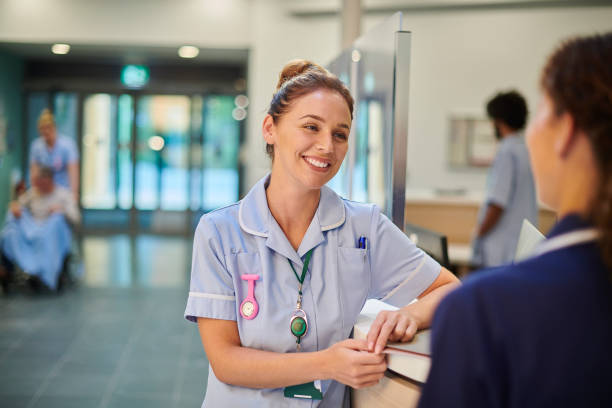 nurse chatting to staff nurse stock photo