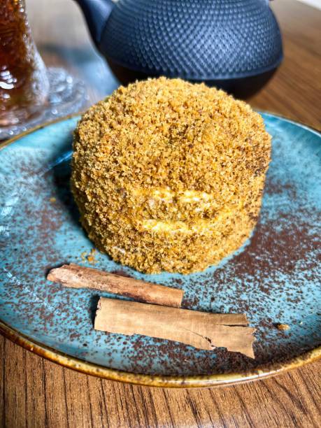 istock Honey Cake With Cinnamon Sticks on Blue Plate 2163194195