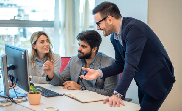 istock Business professionals collaborating on investments and teamwork, using a computer during a meeting, and working in partnership on the stock market. 2163194873
