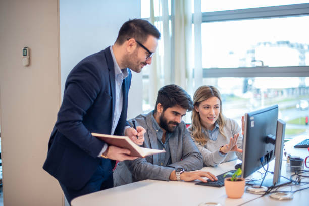 istock Group of business people using computer having a meeting or presentation in the office 2163195038