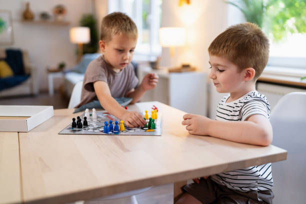 Kids playing ludo game at home.