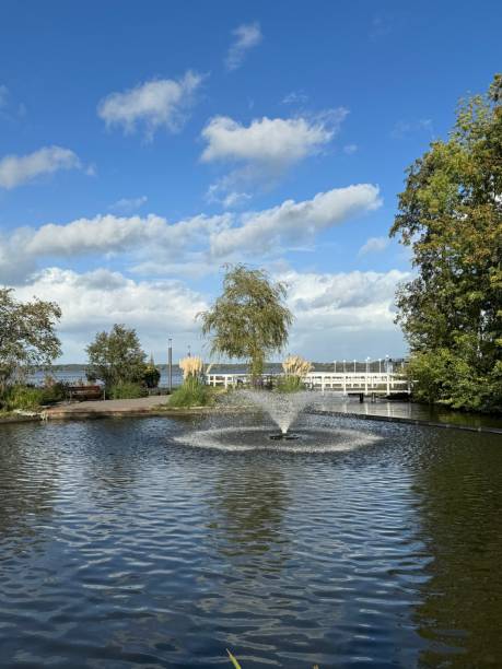 istock Calm pond with splashing fountain 2163197482