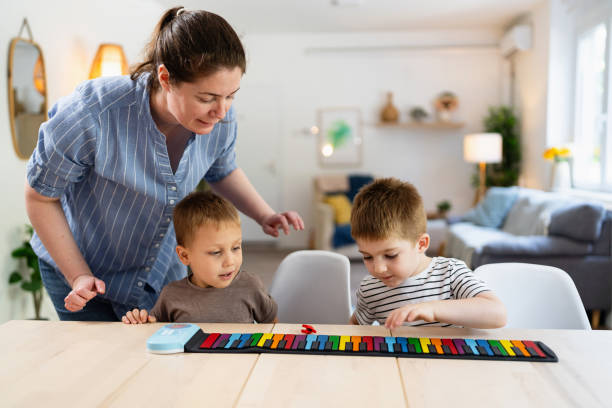 Mom teaching her two sons how to play the keyboard.