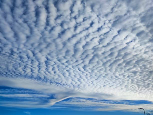 istock beautiful crepuscular rays emanating from fluffy white bobby clouds in the sky, skyscape, cloudscape united kingdom. South Wales. 2163204507