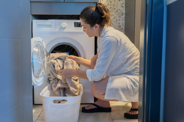 Putting Clothes Into The Drum Of Washing Machine