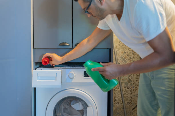 istock Pouring Liquid Detergent Gel In Washing Machine 2163204662