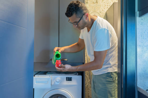 istock Pouring Liquid Detergent Gel In Washing Machine 2163204670