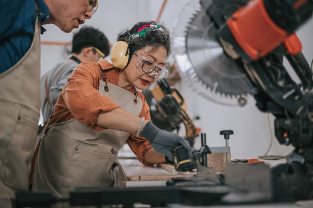 istock asian carpenter conducting woodwork classes to senior student in woodshop workshop 2163204870