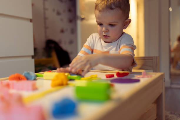 istock Boy playing and creating from modeling clay or plasticine at home 2163208289