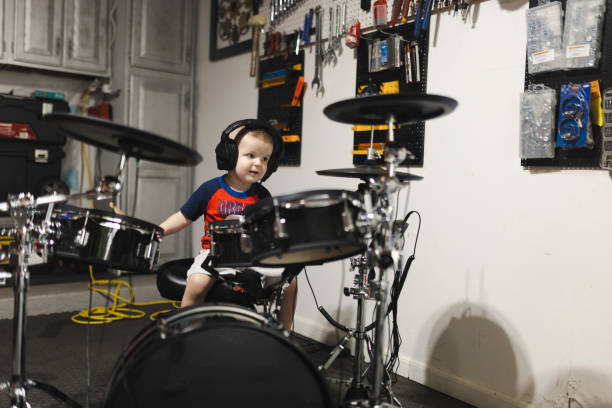 istock Little drummer playing drums while listening music 2163208308