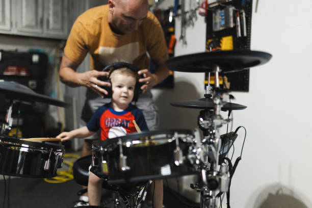 istock A father teaching his cute little son to play the drums 2163208309
