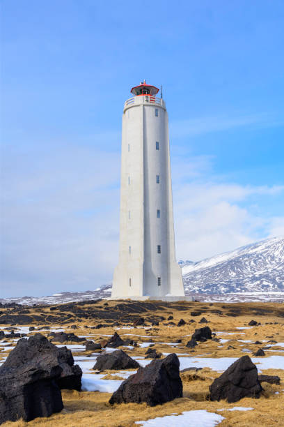 Malarrif lighthouse is located on the seashore of Snaefellsnes peninsula. It is a beautiful rocket shaped lighthouse 20m tall, built in 1917 and then rebuilt in 1946. For decades, the old lighthouse had an essential role for Icelandic fishermen as they fished in the rich fishing grounds by the shore.\nMalarrif lighthouse is standing on the cliffs of a black pebbled beach near the Visitor Center of Snæfellsjökull National Park. The Visitor´s Centre is full of information about the glacier, and many other interesting places at Snaefellsnes Peninsula.\nMalarrif Lighthouse, Snaefellsnes Peninsula, Iceland, Europe.