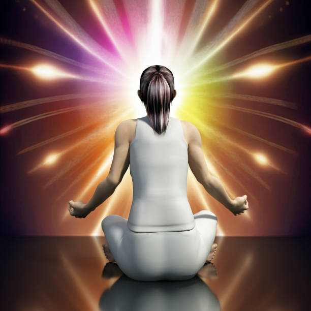 A woman sits in a meditative pose with her back to the viewer, facing a bright light in the distance. The light is emanating a multicolored glow, creating an aura around her.