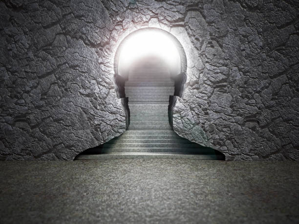 A silhouette of a head is carved into a stone wall, with a stairway leading up through the head.